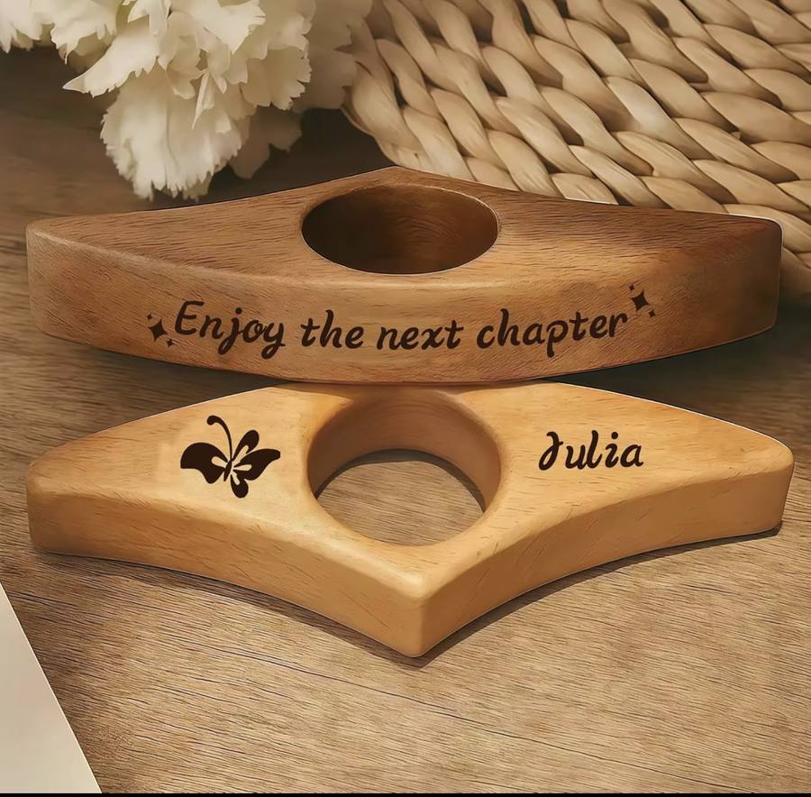 Two engraved page holders on a table, one walnut and one beech